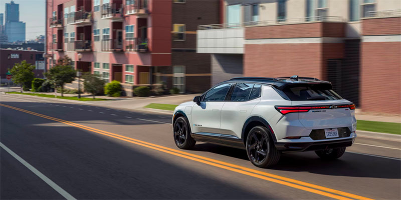 2025 Chevrolet Equinox EV driving down a city street